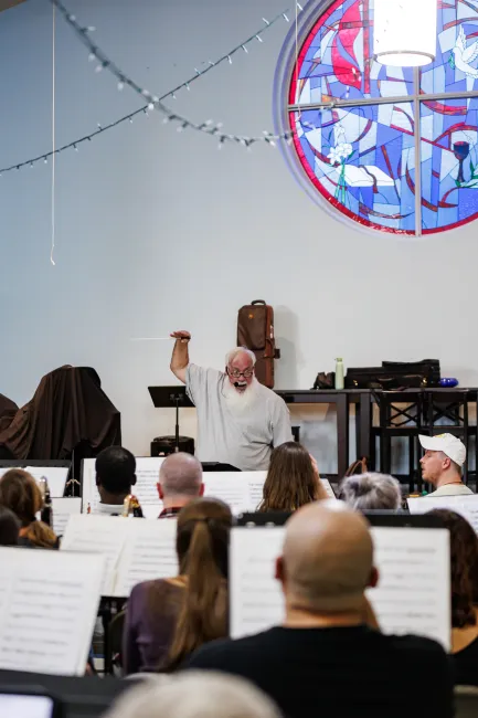 Robert conducts an ACWE rehearsal